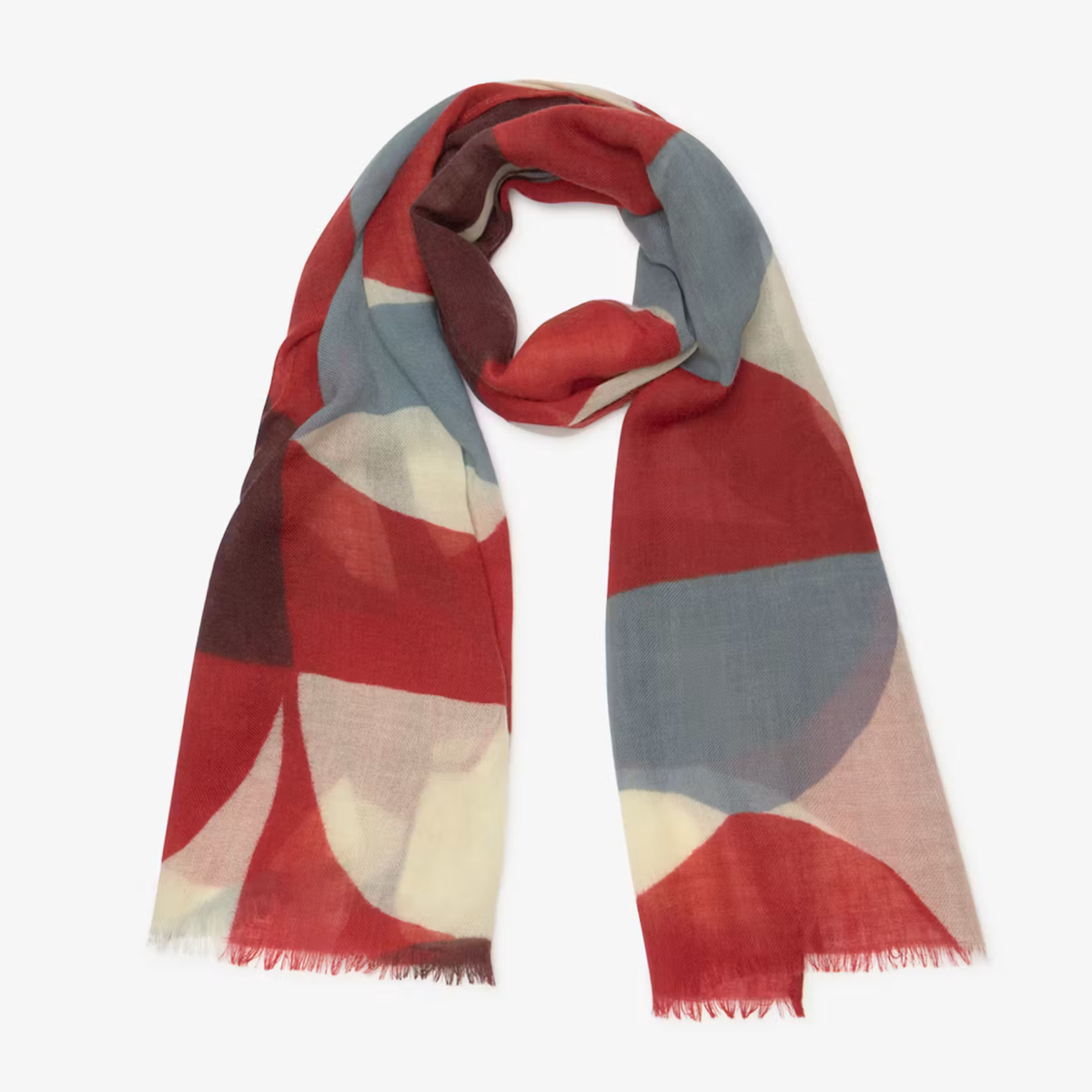 A lightweight scarf with a large-scale abstract geometric pattern in red, dusty blue, cream, and dark brown, finished with fringed edges and displayed on a clean white background.