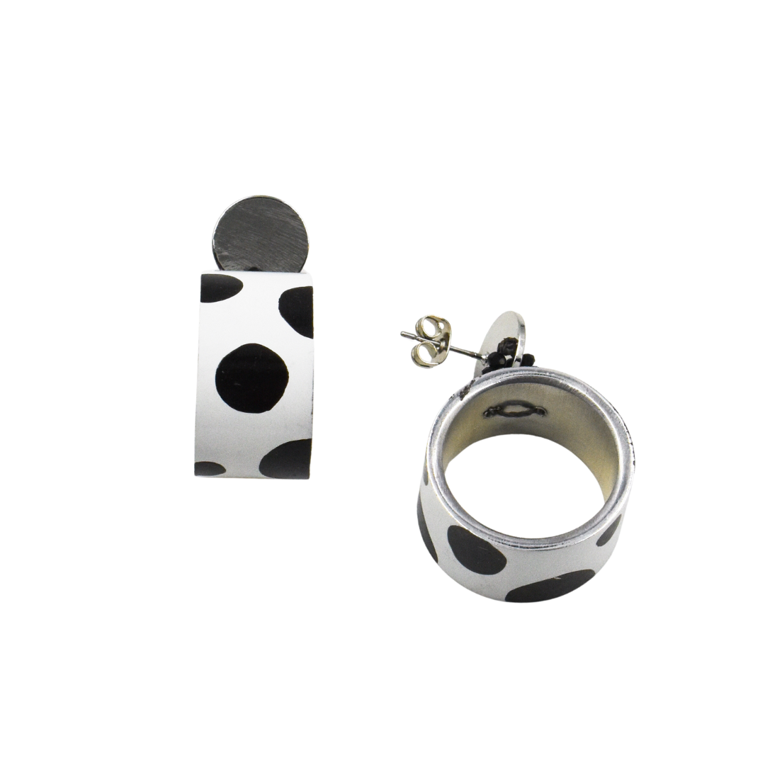 Pair of black and white polka dot hoop earrings.  Silver-toned metal accents.