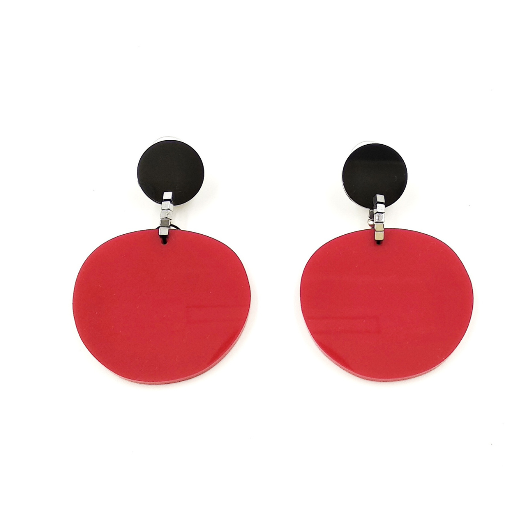 Pair of red and black circular drop earrings.