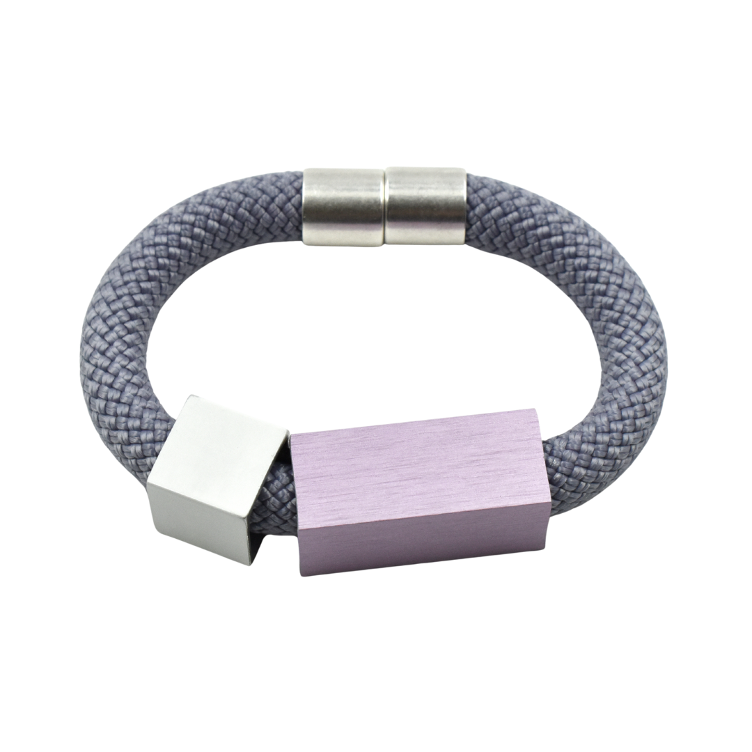 Gray rope bracelet with silver clasp and lilac and silver rectangular accents.