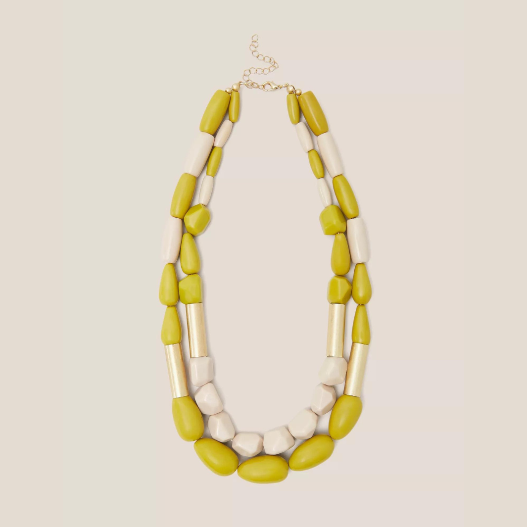 Double-strand necklace with olive green and off-white chunky beads and gold accents.