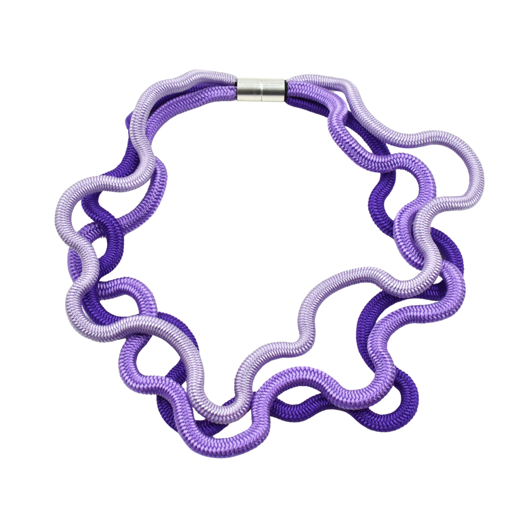 Purple and lavender ombre necklace made of interwoven, wavy cords; silver magnetic clasp.