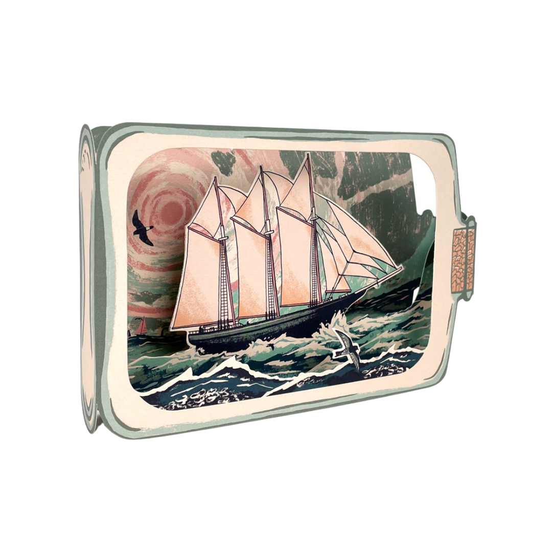 Pop-up card depicting a three-masted schooner sailing on a stylized ocean, inside a message-in-a-bottle design.