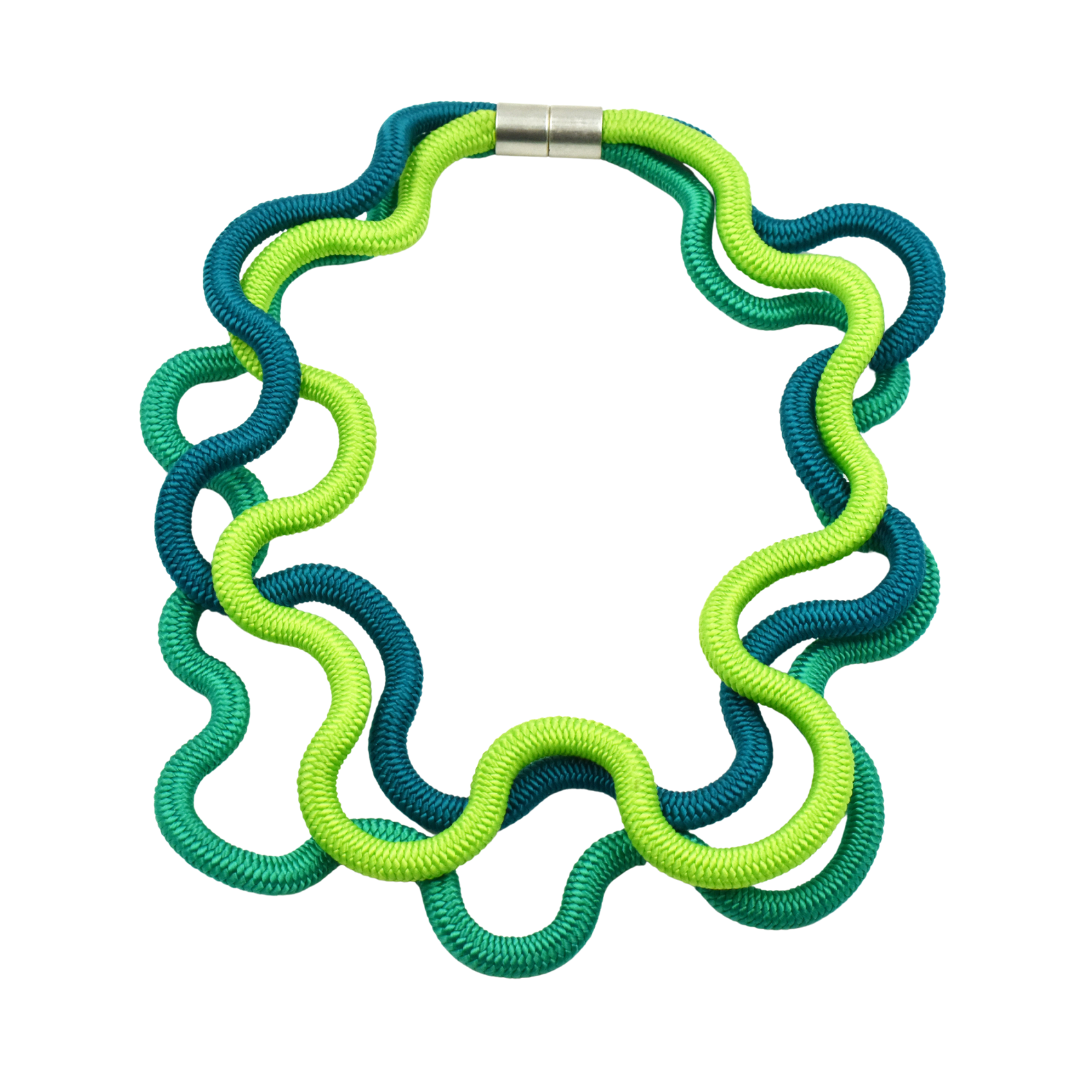 Necklace of interwoven teal and lime green cords, forming a wavy, organic shape; magnetic clasp.