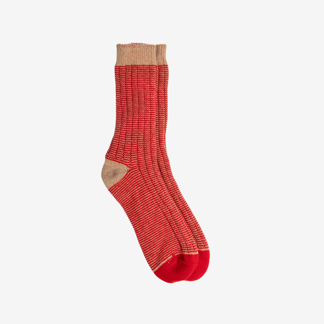 Red sock with beige trim on a white background