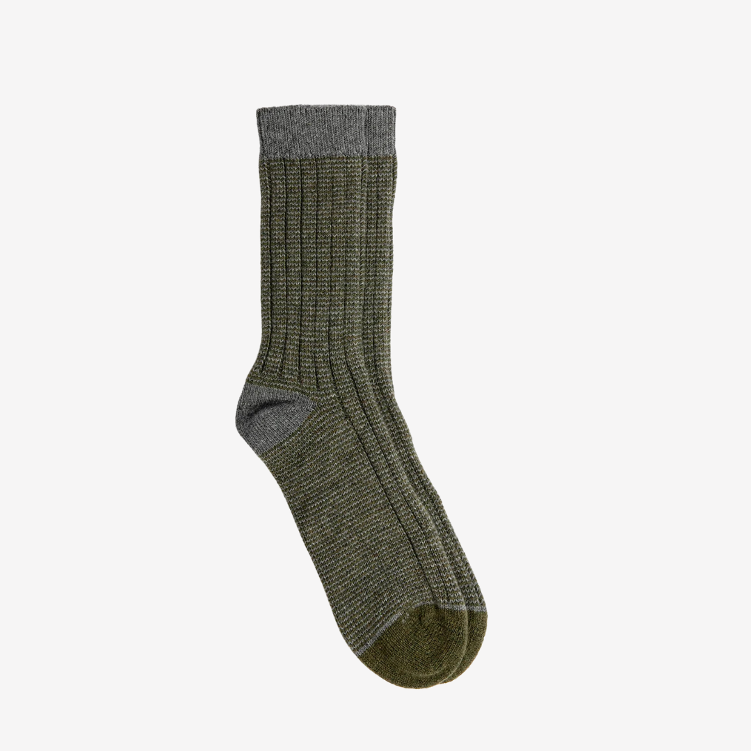 Green sock with gray cuff on a white background