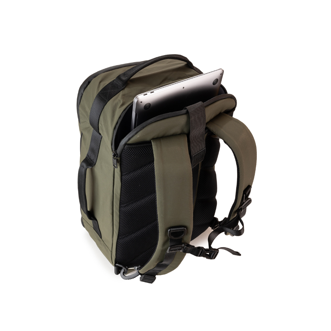 Olive green backpack with black accents, showing a laptop stored in a dedicated compartment.