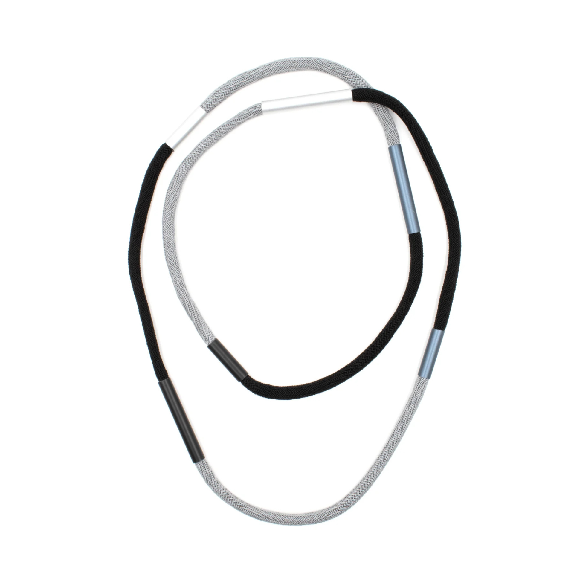 A coiled gray braided cord with black and light blue segmented sections, isolated on a white background.