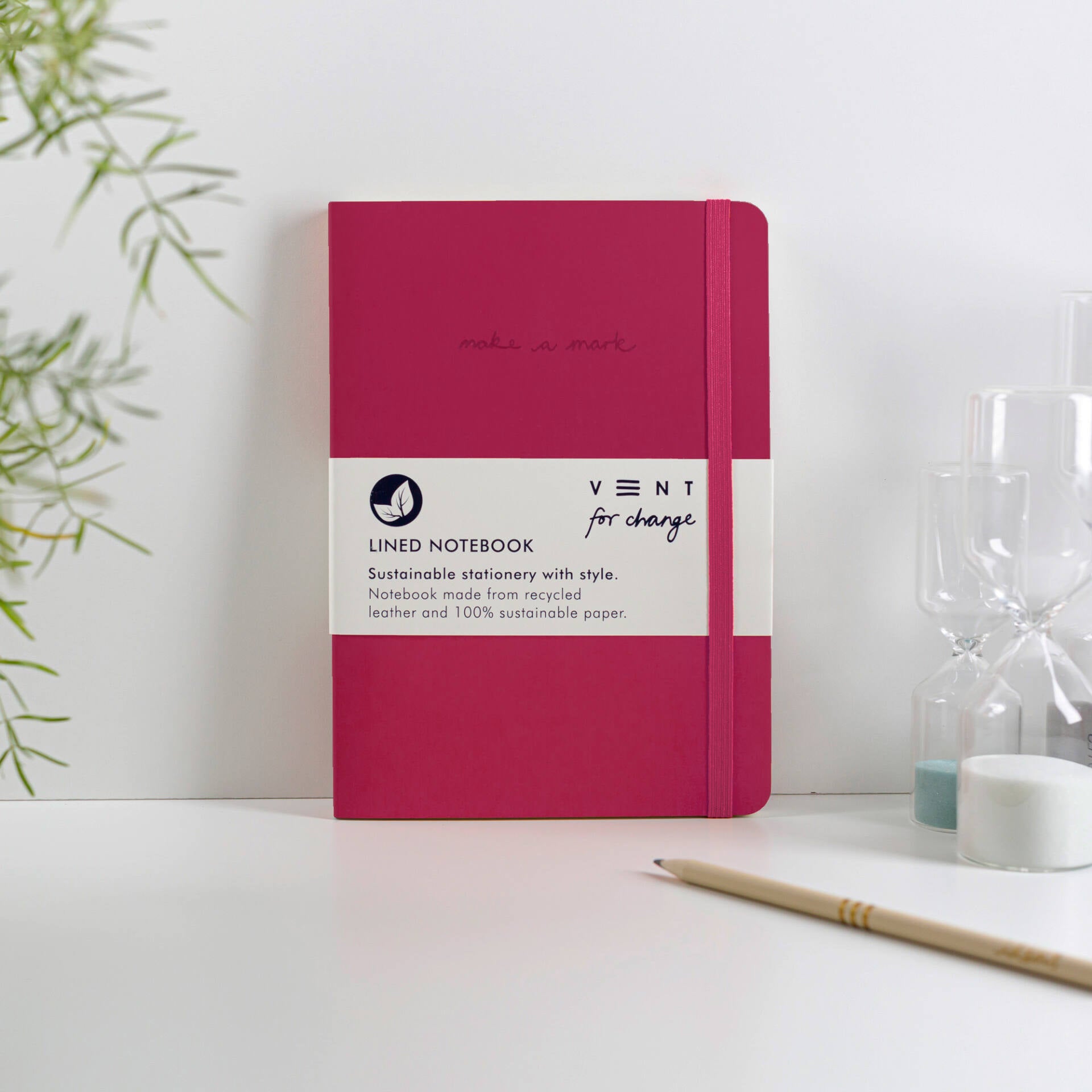 Crimson lined notebook with elastic closure; made from recycled leather and sustainable paper.