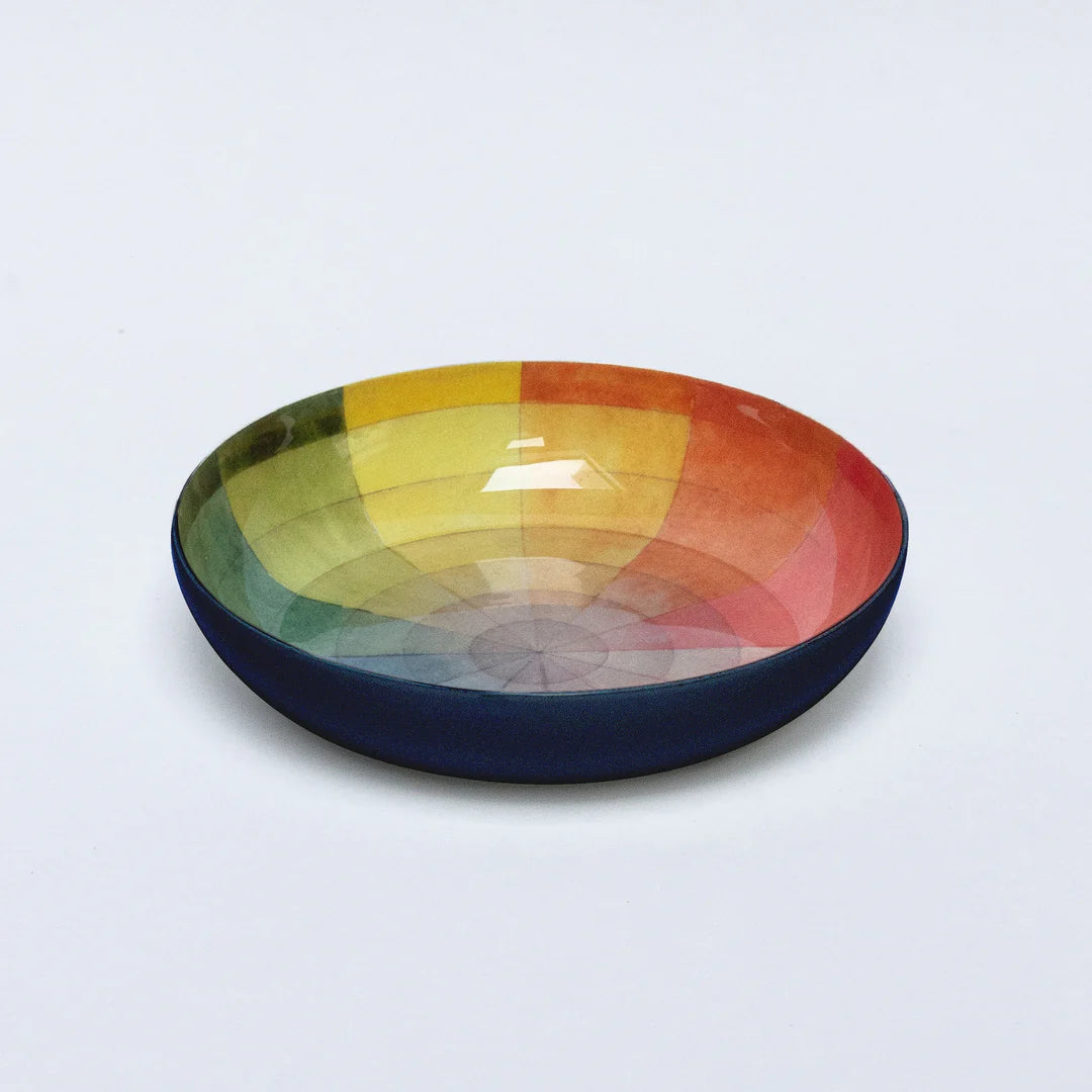 Multicolored bowl with a gradient from green to red on a light gray background