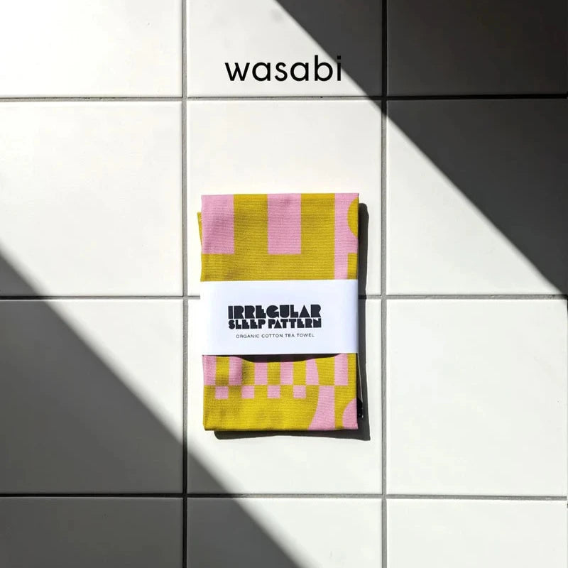 Mustard yellow and pink organic cotton tea towel with geometric pattern; "Irregular Sleep Pattern" label.