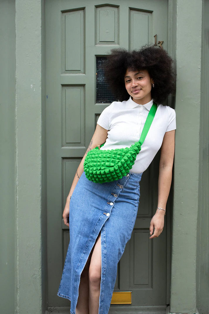 Bright green textured crossbody bag with a lime green strap.