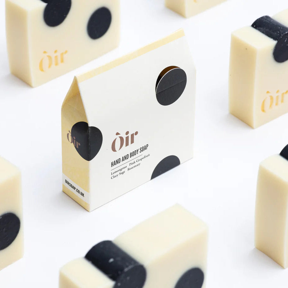 -bars of soap with black dots on them, packaged in a minimalistic white box with the brand name 'Oir' printed on it. Sent of Lemongrass, Pink Grapefruit, Clary Sage and Rosemary. 