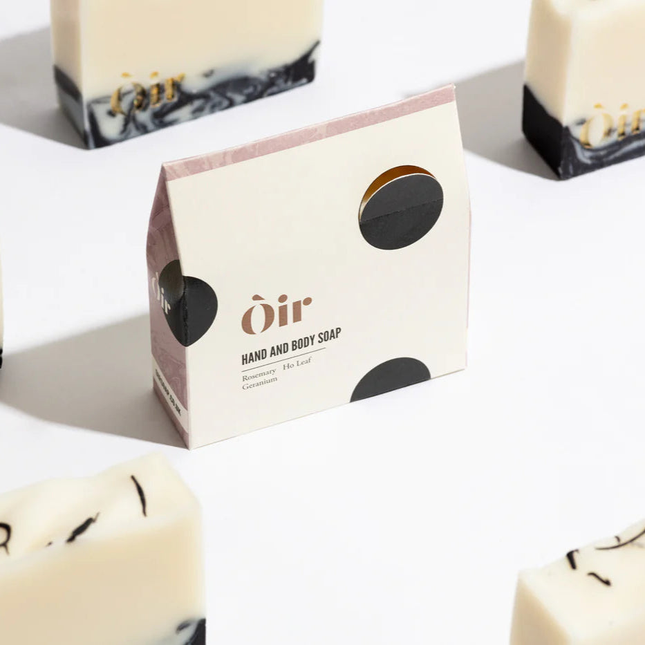 -bars of soap with packaging that has 'Oir' brand and 'Hand & Body Soap' product name written on it, against a white background.