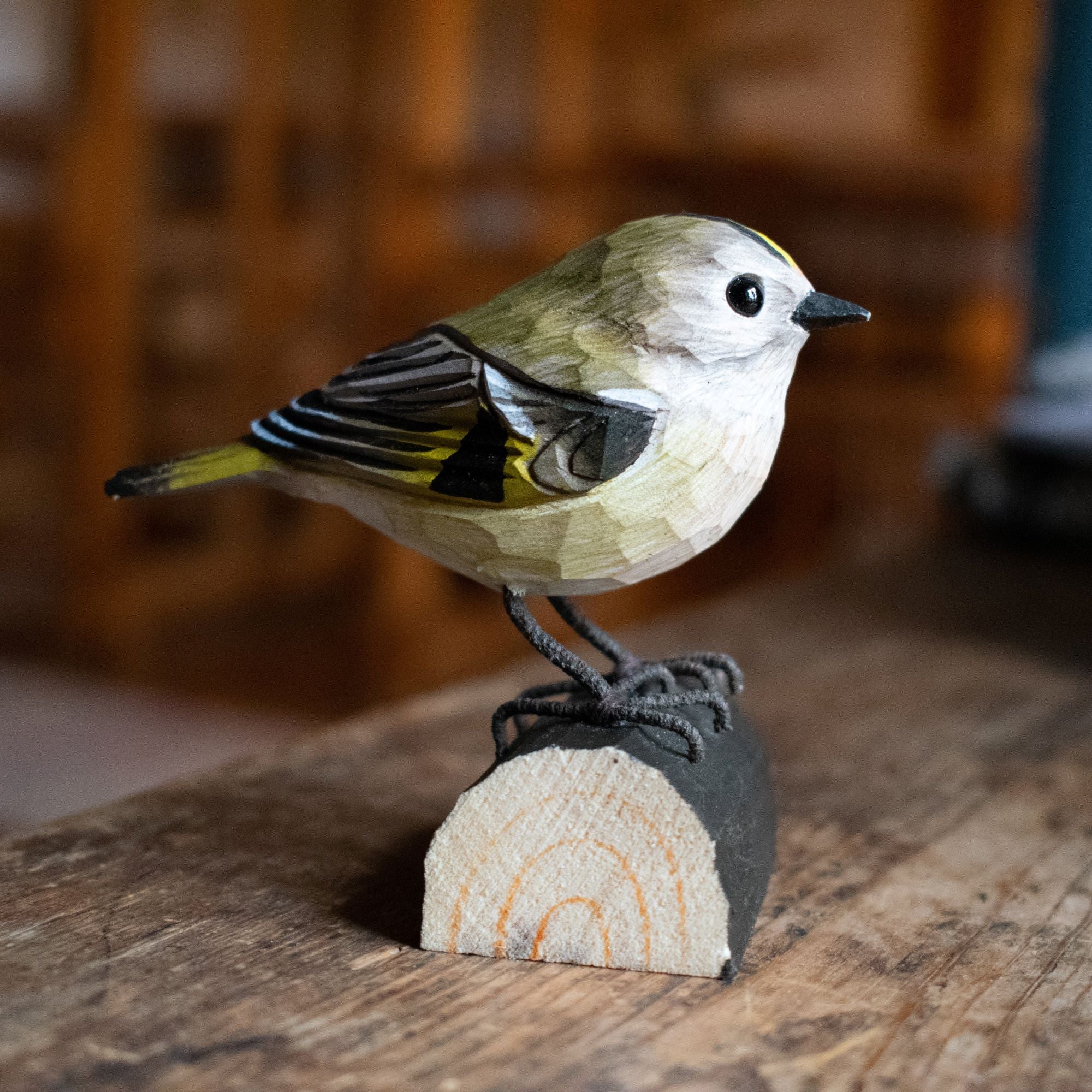 Bird perched on a wooden log with a blurred background