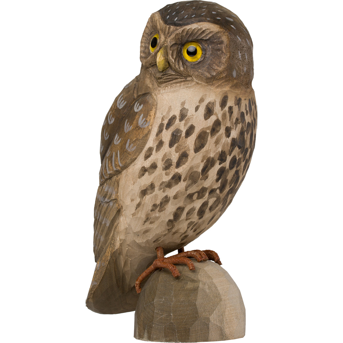 A hand-carved wooden owl figurine with detailed brown and beige wood grain patterns, bright yellow eyes, and orange-brown claws, standing on a small log base against a plain white background.