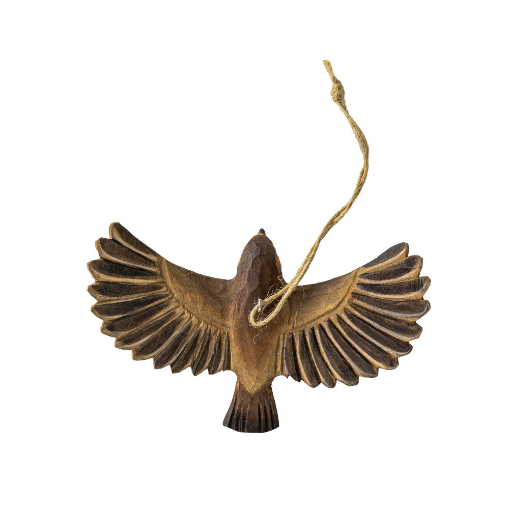 Wooden bird ornament with outstretched wings on a white background