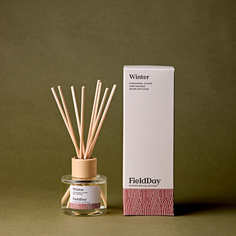 Diffuser with wooden sticks and packaging labeled 'Winter' by FieldDay on a green background