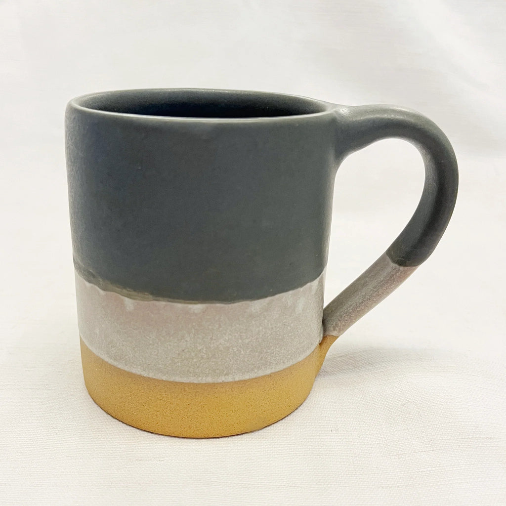 Stoneware mug with a dark gray top, a light gray middle band, and a mustard yellow bottom.