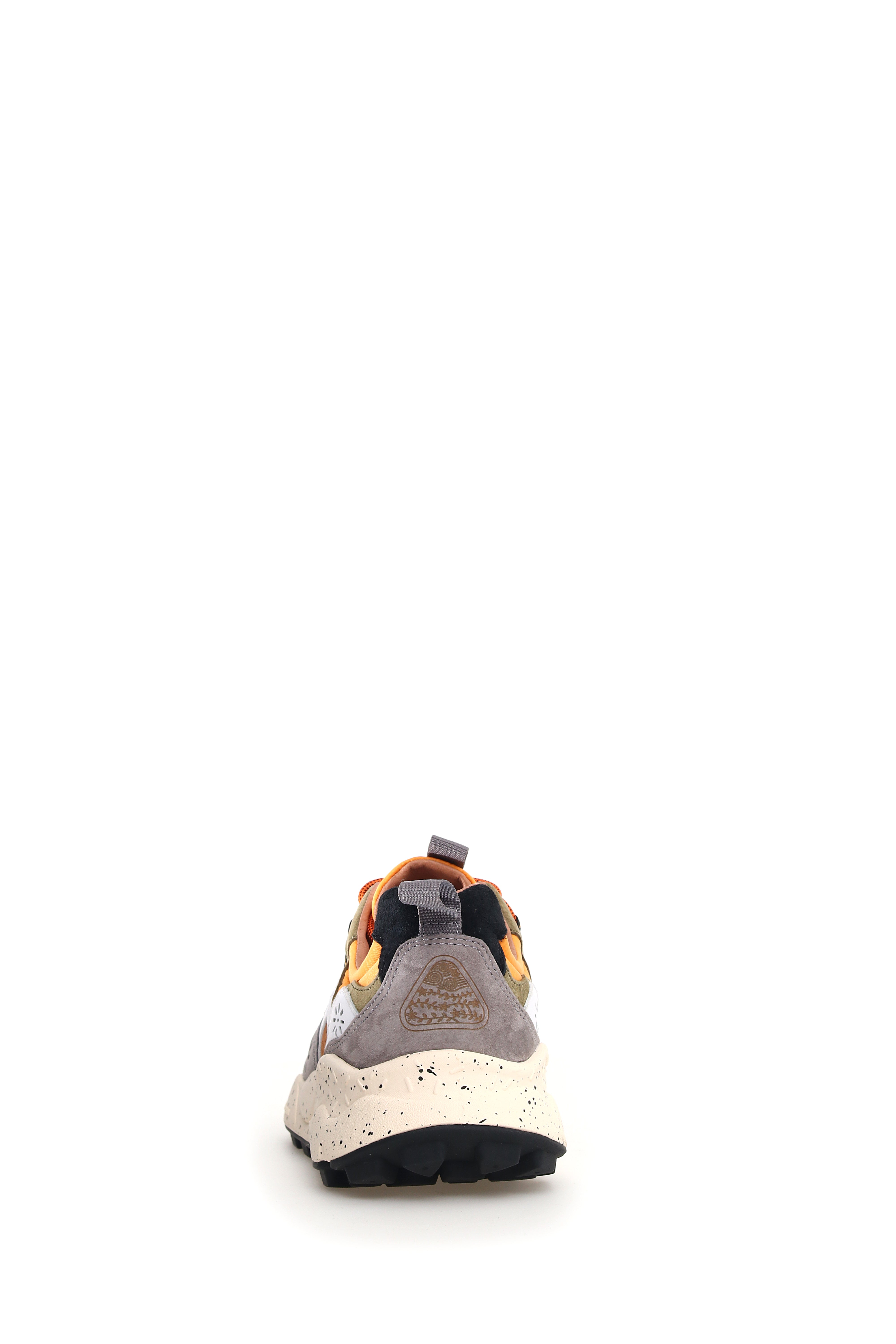 Rear view of a gray, orange, and black sneaker with a chunky off-white sole and a patterned detail on the heel.