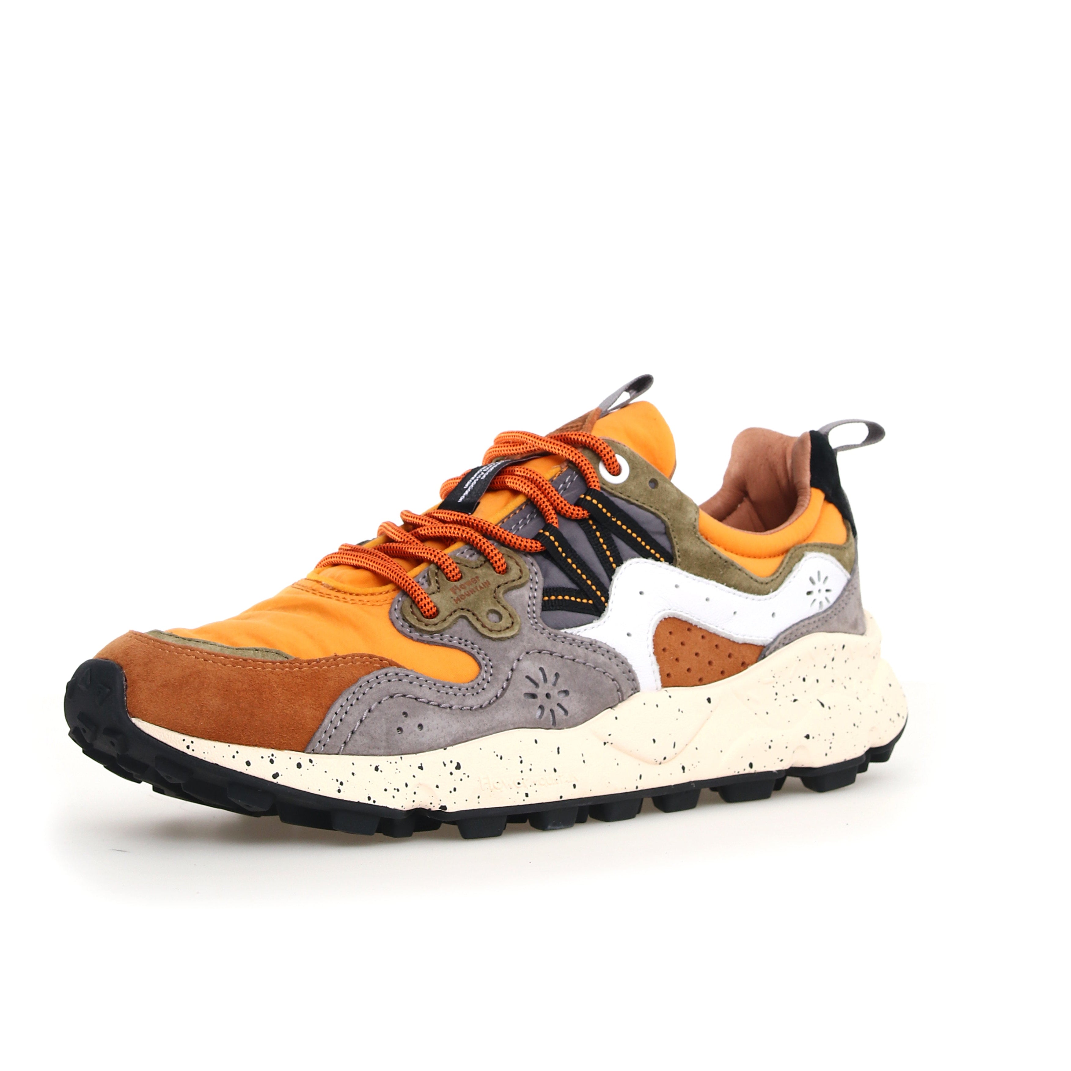 Multi-colored low-top sneaker with orange, brown, gray, and white panels.  Features a chunky, speckled sole and orange laces.