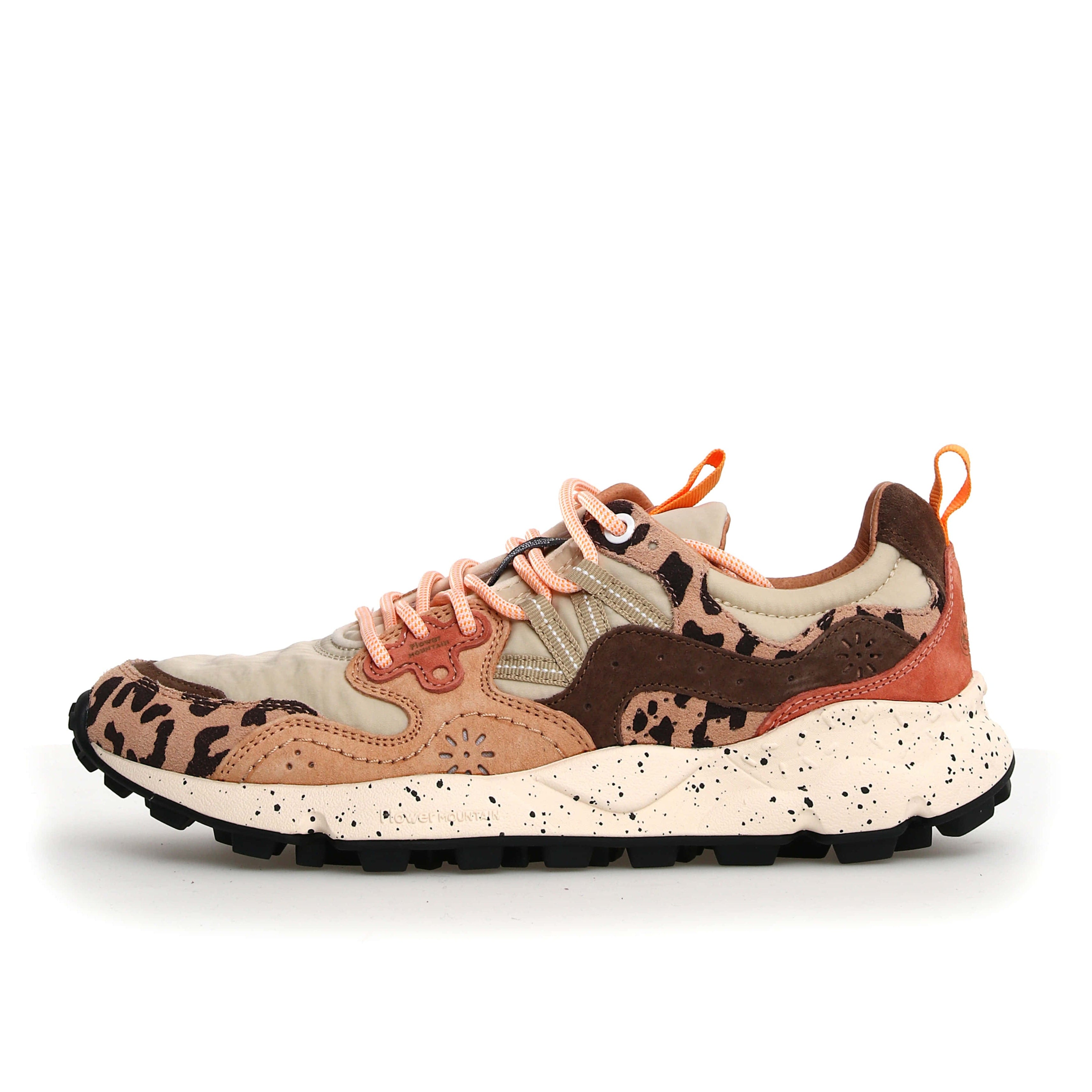 Beige and brown low-top sneaker with orange laces and a leopard print detail.  The shoe features a chunky, speckled sole.