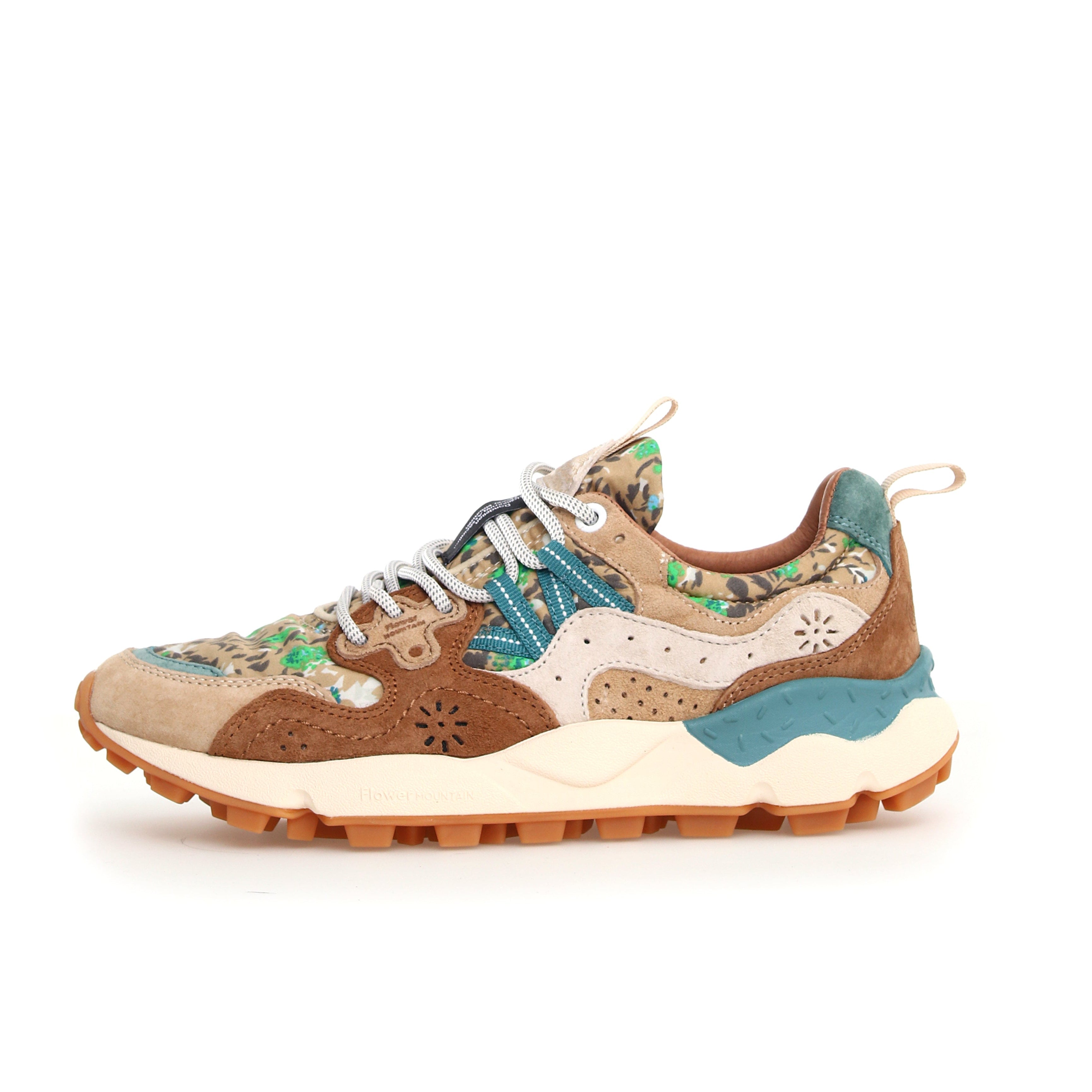 Brown and beige floral patterned sneaker with teal accents and a chunky, textured sole.
