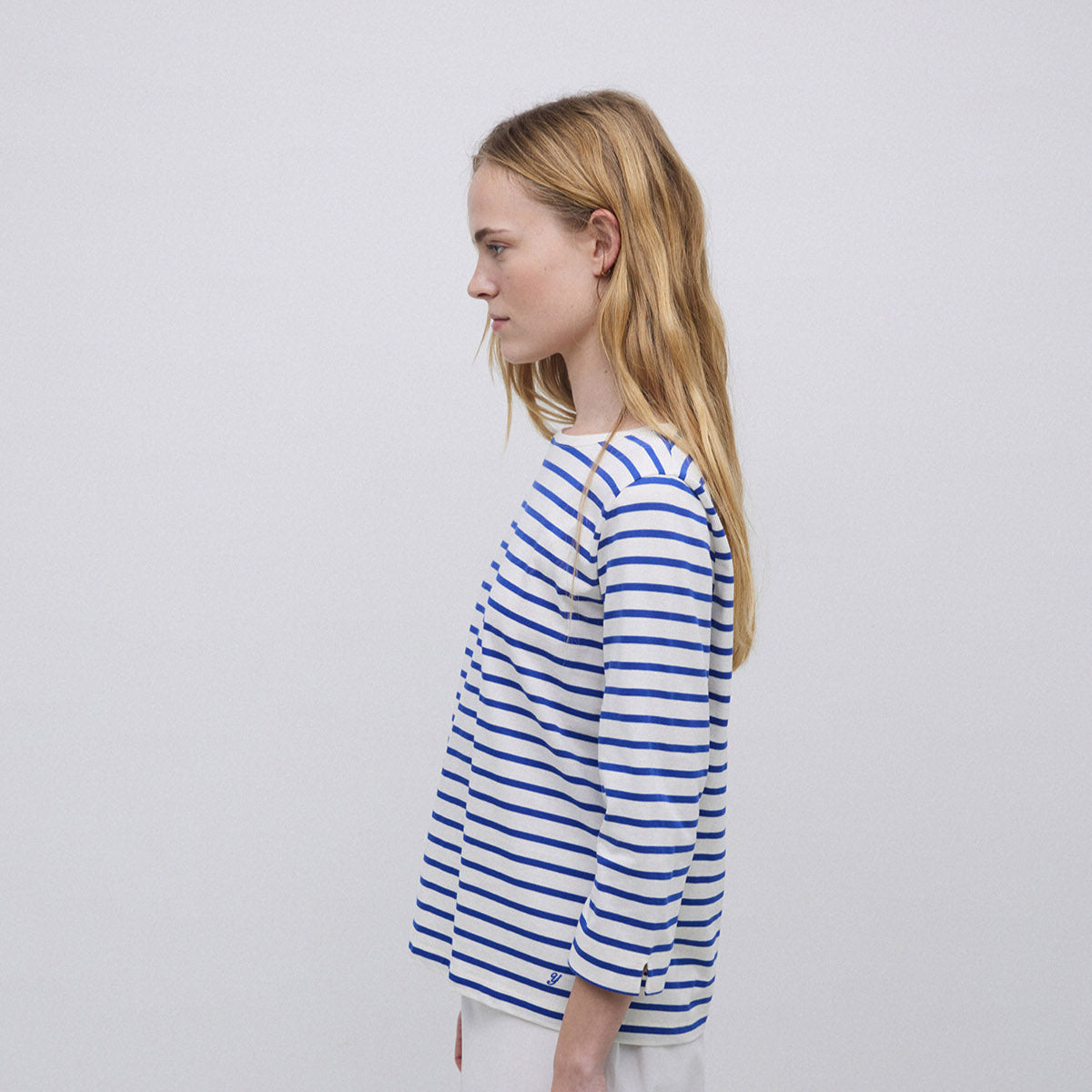 White and blue horizontally striped women's three-quarter sleeve shirt.