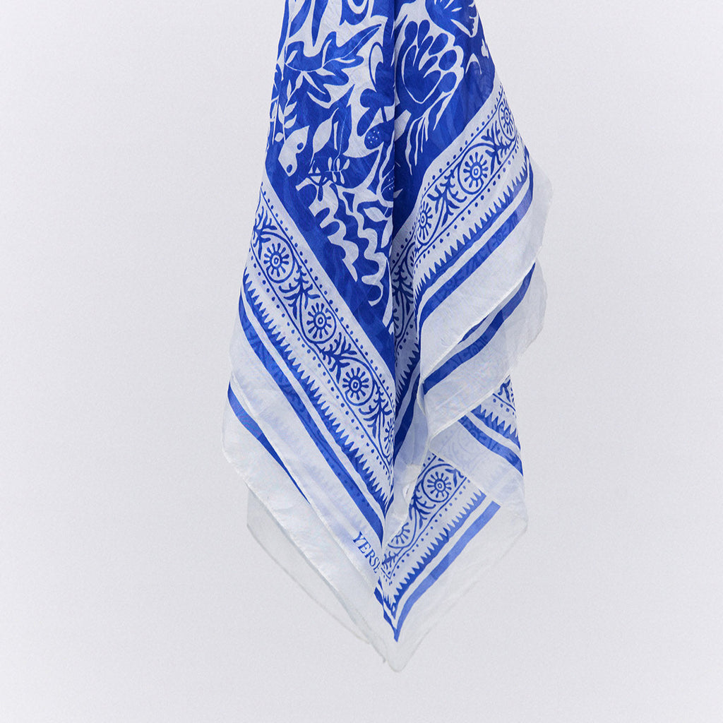 silk square scarf with intricated blue and white floral design with detailed designed border. 