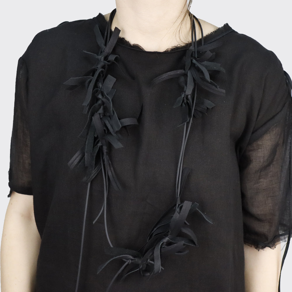 Black leather necklace with frayed, knotted detailing.
