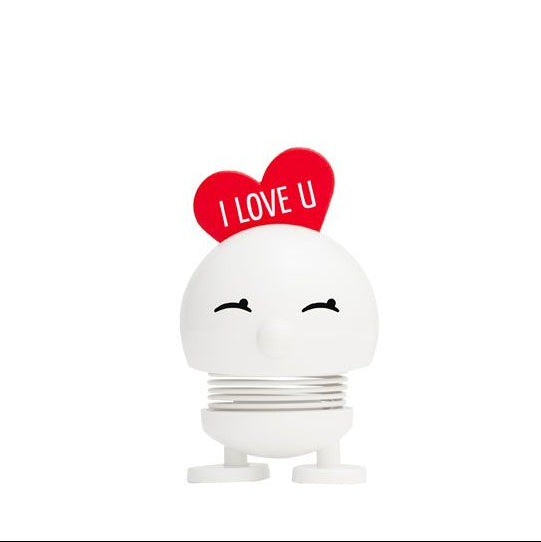 White bobblehead toy with a red heart that says "I LOVE U" on top.  It has a spring-loaded base and a smiling face.