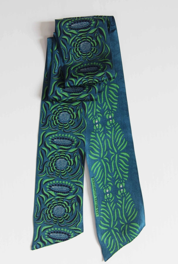 Green and blue patterned tie on a white background