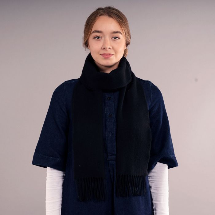 Black cashmere scarf with fringed edges.