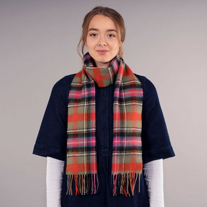 Red, green, and black plaid wool scarf with fringed edges.