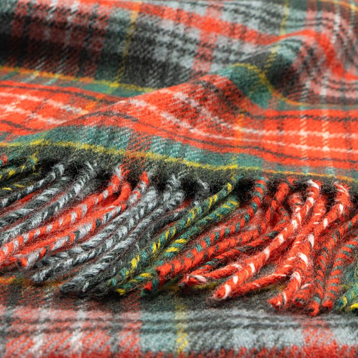 Red, green, and gray plaid wool scarf with fringed edges.