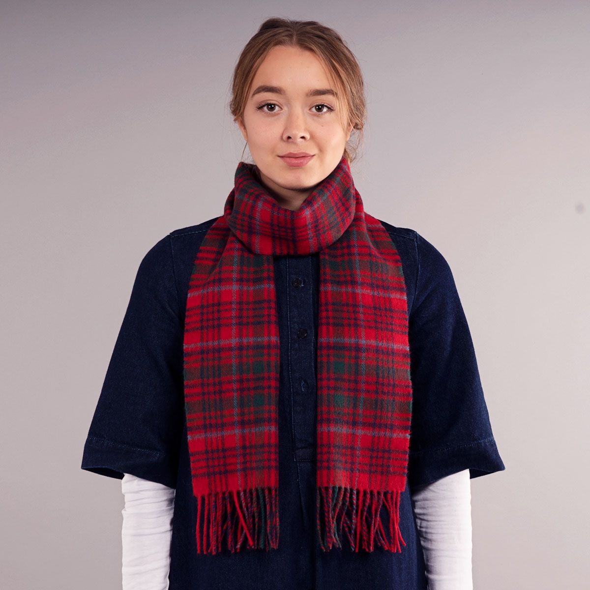 Red and green plaid wool scarf with fringed edges.