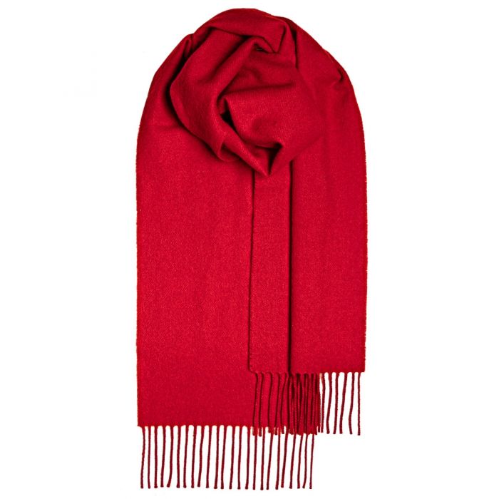 Solid red cashmere scarf with fringed edges, folded and displayed.