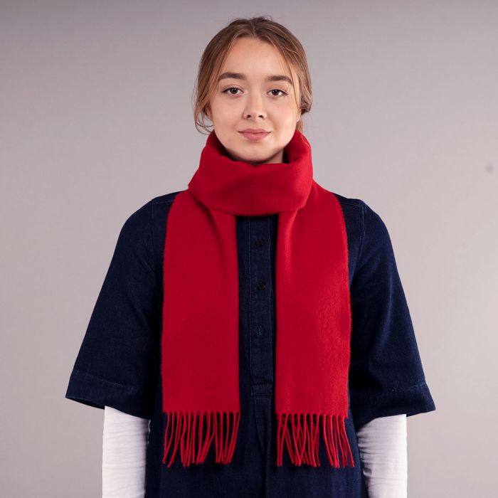 Red cashmere scarf with fringed edges.