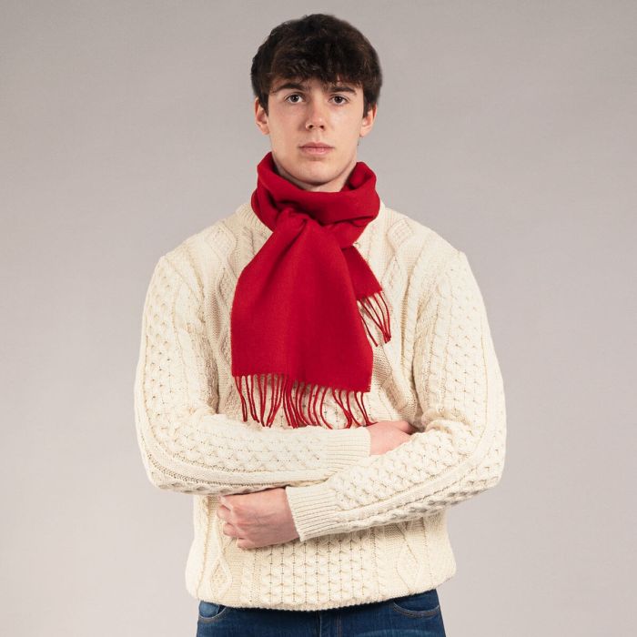 Red wool scarf with fringed edges.