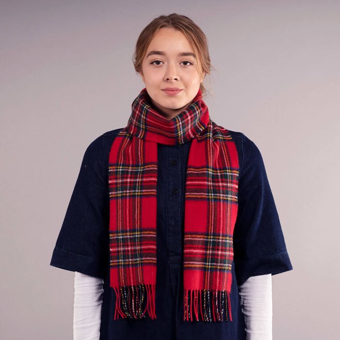 Red and navy plaid wool scarf with fringed edges.