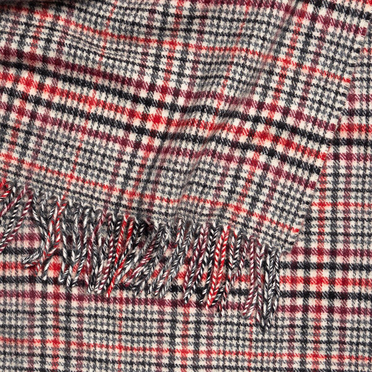 Red and black plaid wool throw blanket with fringe.