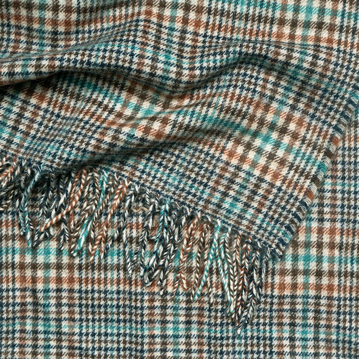 Woven plaid throw blanket with teal, brown, and beige pattern and fringed edge.