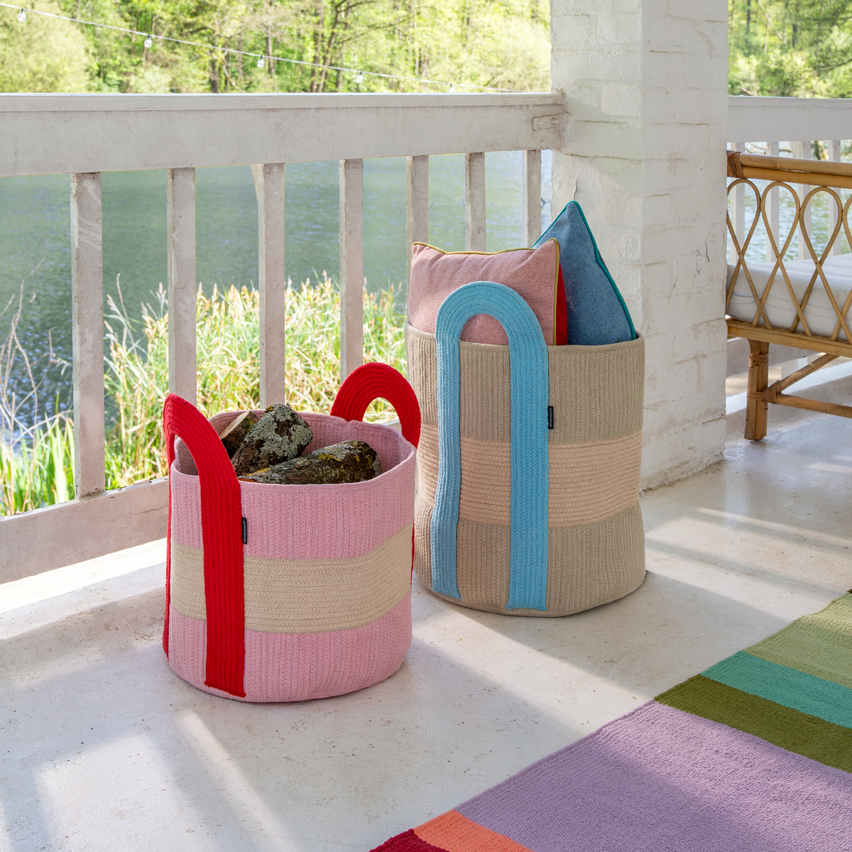 Colorful woven baskets on a porch with a scenic background