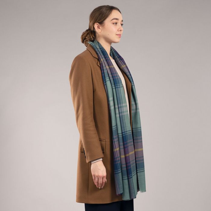 A teal, purple, and navy plaid wool scarf.