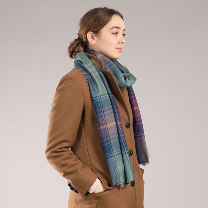 A teal and purple plaid wool scarf.