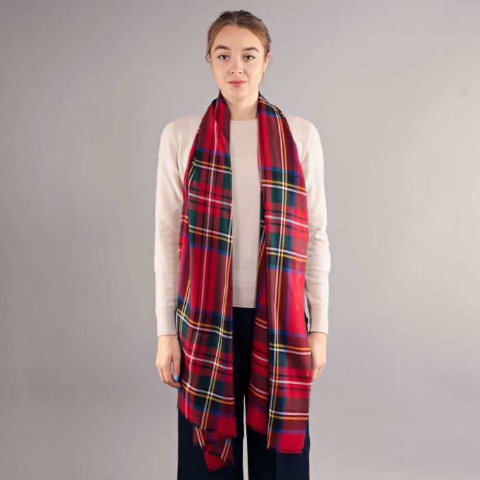 Red and green plaid wool scarf, long and rectangular, with fringed edges.
