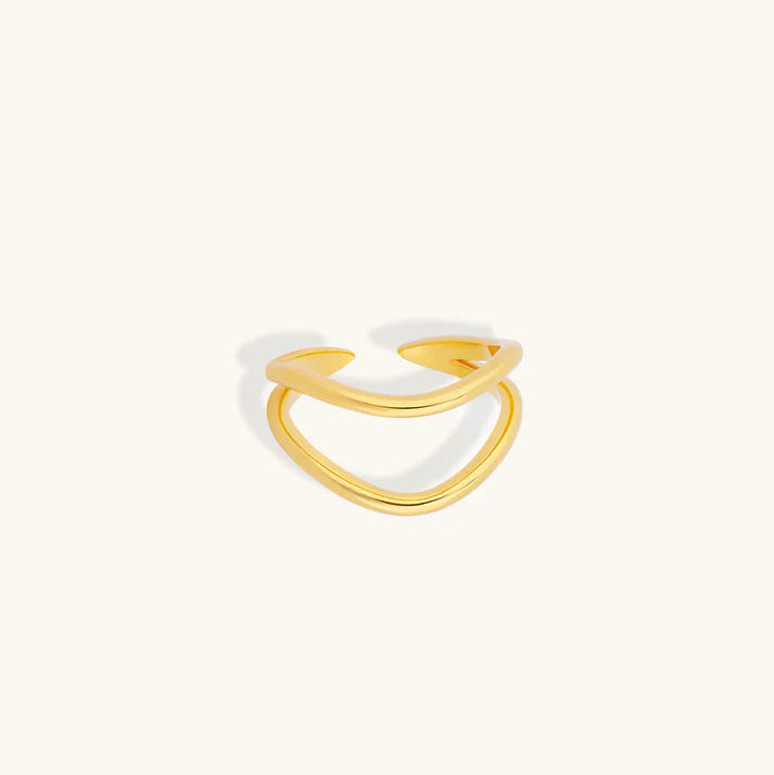 A thin, open-ended gold ring with a smooth, polished finish, displayed on a clean, off-white background.