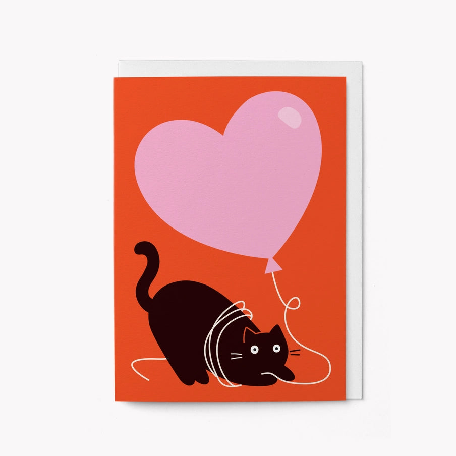 Cat with pink heart balloon greeting card