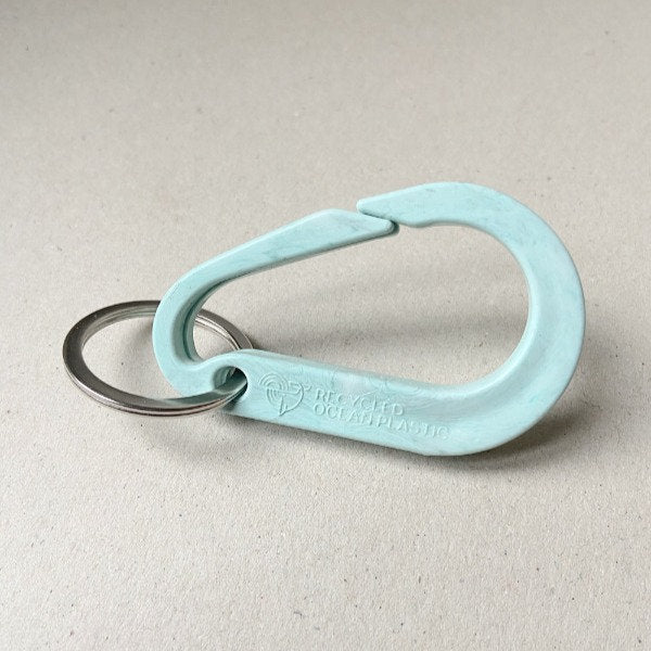 Light teal carabiner keychain made from recycled ocean plastic.