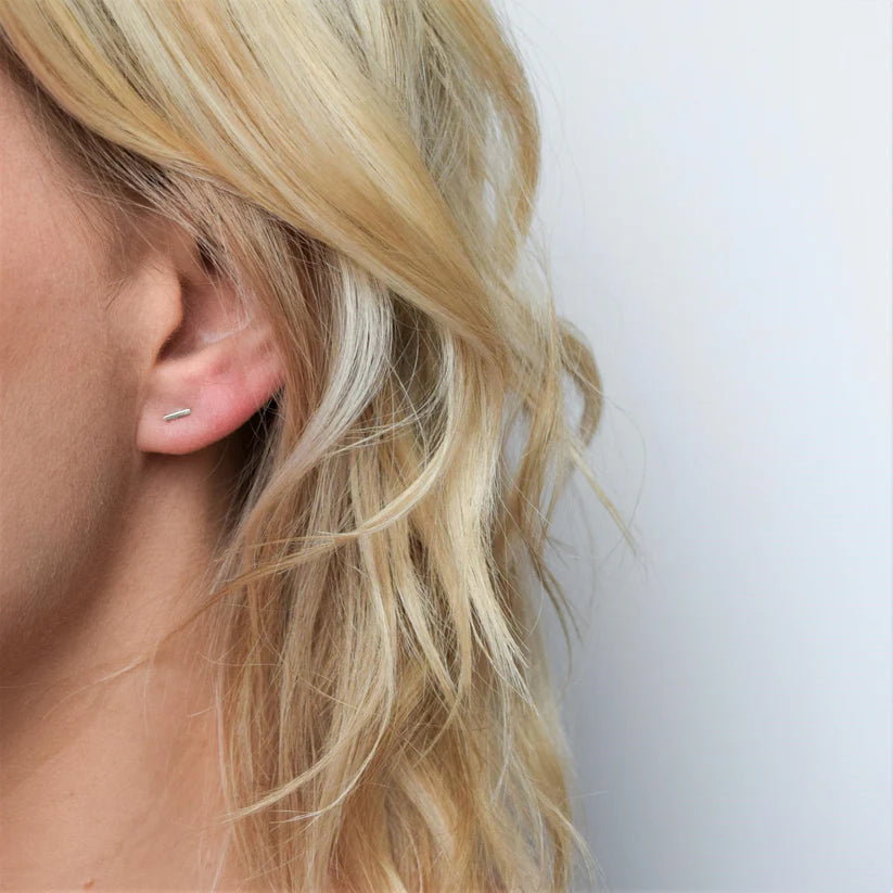Delicate silver bar stud earring. Minimalist design.